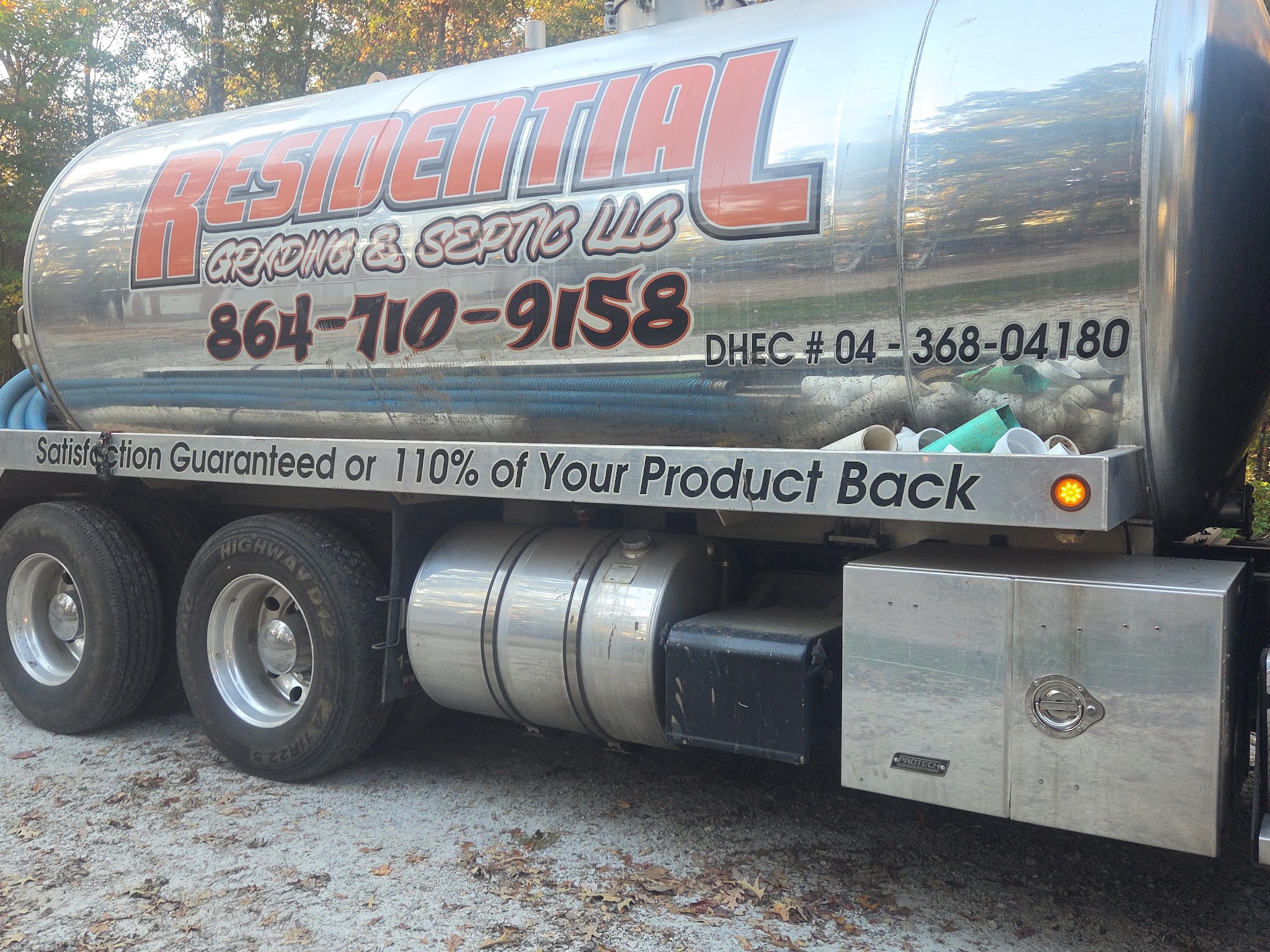 Close-up of our stainless tanker with the company name and phone number